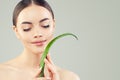 Spa beauty portrait of beautiful young woman with green aloe vera leaf. Skincare and facial treatment concept Royalty Free Stock Photo