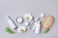 Spa, beauty treatment and wellness background with massage brush, orchid flowers and cosmetic products. Top view and flat lay Royalty Free Stock Photo