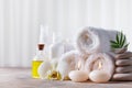 Spa, beauty treatment and wellness background with massage pebbles, orchid flowers, towels, cosmetic products and burning candles