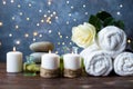 Spa, beauty treatment and wellness background Towel Cosmetic Massage oil, flowers, lights and candel