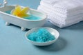 Spa and body care products. Aromatic blue bath Dead Sea Salt on the blue background.