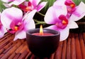 Spa candle and orchid flower for aromatherapy Royalty Free Stock Photo