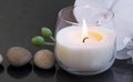 Spa candle , wellness and spa setting with massage stones and white orchid Royalty Free Stock Photo