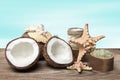 Spa coconut products and marine accessories on wooden boards, on turquoise background