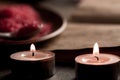 Spa composition with aroma candles and empty vintage open book on wooden background. Treatment, aromatherapy Royalty Free Stock Photo