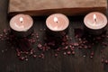 Spa composition with aroma candles and empty vintage open book on wooden background. Treatment, aromatherapy Royalty Free Stock Photo