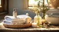 Spa composition with aromatic candles, towels and cotton flowers on table in room. Beauty spa treatment and relax concept