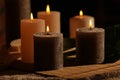 Spa composition with burning candles on massage table in wellness canter, closeup