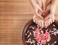 A spa composition of feet and hands in a bowl Royalty Free Stock Photo