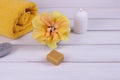 Spa composition with hibiscus flower, towel, soap and candle on a white wooden background. Copy space Royalty Free Stock Photo