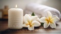 Spa composition massage herbal ball, plumeria flower in vase,coconut coffee soap,white towels and candle on white wood table Royalty Free Stock Photo