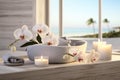 Spa composition with ocean view, towels and orchid flowers on wooden table. Beauty, health and relaxation concept. Generative AI