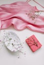 Spa composition with pink soap bar with ceramic soap dish, silk babric and flowers Royalty Free Stock Photo