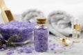 Purple sea salt in a glass bottle against the background of essential oils and bath accessories Royalty Free Stock Photo