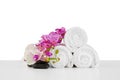 Spa composition with towels and flowers isolated on white Royalty Free Stock Photo