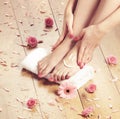 Spa compositions of female feet and rose petals Royalty Free Stock Photo