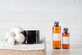 Spa concept. Body scrub in dark glass jar on a pile of cotton towels on wooden table. Skin care concept