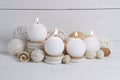 Spa concept of burning white candles decorated with natural dried potpourri