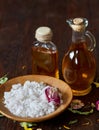 SPA concept: composition of spa treatment with natural sea salt, aromatic oil and flowers on wooden background Royalty Free Stock Photo