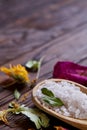 SPA concept: composition of spa treatment with natural sea salt, aromatic oil and flowers on wooden background Royalty Free Stock Photo