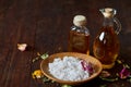 SPA concept: composition of spa treatment with natural sea salt, aromatic oil and flowers on wooden background Royalty Free Stock Photo