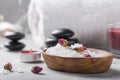 SPA concept: composition of spa treatment with natural sea salt, aromatic oil and flowers on wooden background, close up, top view Royalty Free Stock Photo