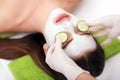 Spa concept. Hand applying nourishing mask on female face in spa salon Royalty Free Stock Photo