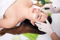 Spa concept. Hand applying nourishing mask on female face in spa salon Royalty Free Stock Photo