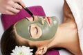 Spa concept. Hand applying nourishing mask on female face in spa Royalty Free Stock Photo