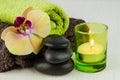 Spa concept with lava stones, orchid and candle Royalty Free Stock Photo