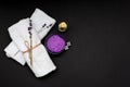 Spa concept. Lavender salt for a relaxing bath, aroma oil, white towels and dry lavender flowers on a black background. Royalty Free Stock Photo