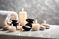 Spa concept, massage black stones with towels and candles. Royalty Free Stock Photo