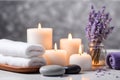 Spa concept, massage stones with towels, candles and lavender flowers. Royalty Free Stock Photo