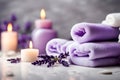 Spa concept, massage stones with towels, candles and lavender flowers. Royalty Free Stock Photo