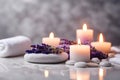 Spa concept, massage stones with towels, candles and lavender flowers. Royalty Free Stock Photo