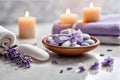 Spa concept, massage stones with towels, candles and lavender flowers. Royalty Free Stock Photo