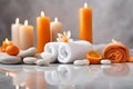 Spa concept, massage stones with towels, candles, orange and leaves.