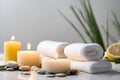Spa concept, massage stones with towels, candles, orange and leaves. Royalty Free Stock Photo