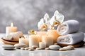 Spa concept, massage stones with towels, candles and white orchids. Royalty Free Stock Photo