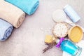 Spa concept, natural ingredients. Bath towels, sea salt with lavender, natural olive soap, shower gel, brush. On a stone Royalty Free Stock Photo