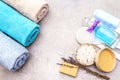 Spa concept, natural ingredients. Bath towels, sea salt with lavender, natural olive soap, shower gel, brush. On a stone Royalty Free Stock Photo