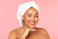 After spa concept. Portrait of chubby black woman with bath towel on head and perfect glowing skin smiling at camera