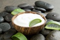 Spa concept. slice aloe vera on white cream in coconut shell wit