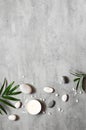 Spa concept on stone background, palm leaves, candle and zen, grey stones, top view Royalty Free Stock Photo