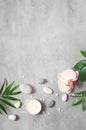 Spa concept on stone background, palm leaves, flower, candle and zen, grey stones, top view Royalty Free Stock Photo