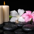 Spa concept of white, pink hibiscus flowers, candles and natural Royalty Free Stock Photo