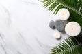 Spa Concept on White Stone Background with Palm Leaves, Flower Candle, and Zen-like Grey Stones - Top View AI Generated Royalty Free Stock Photo