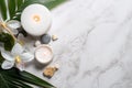 Spa Concept on White Stone Background with Palm Leaves, Flower Candle, and Zen-like Grey Stones - Top View AI Generated Royalty Free Stock Photo