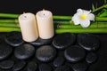 spa concept of zen basalt stones, white flower frangipani, candles and natural bamboo with dew, closeup Royalty Free Stock Photo