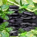 Spa-concept with zen stones and bamboo reflected in a water Royalty Free Stock Photo